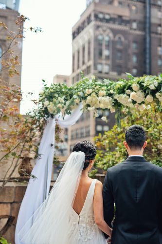 Newlyweds during an outdoor ceremony on gorgeous summer day.